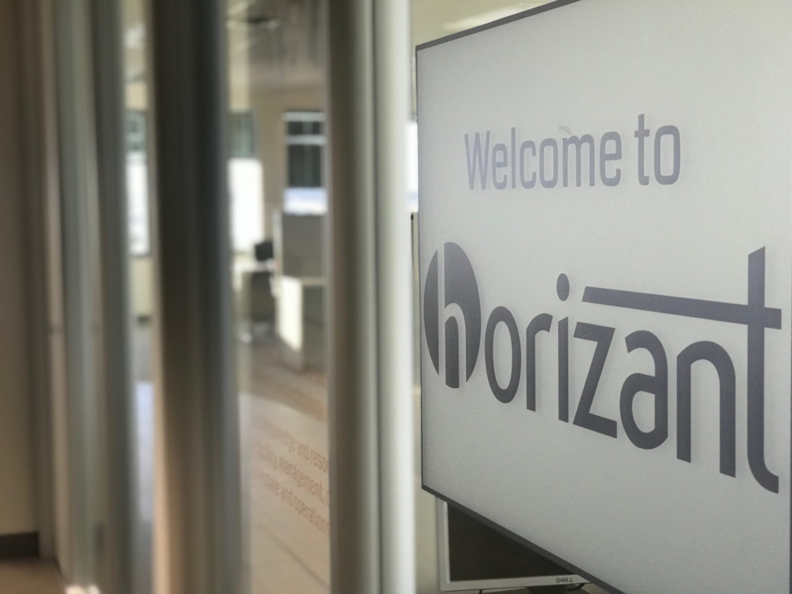 Close up of the 'Welcome to Horizant' sign on the outside of the Horizant building.