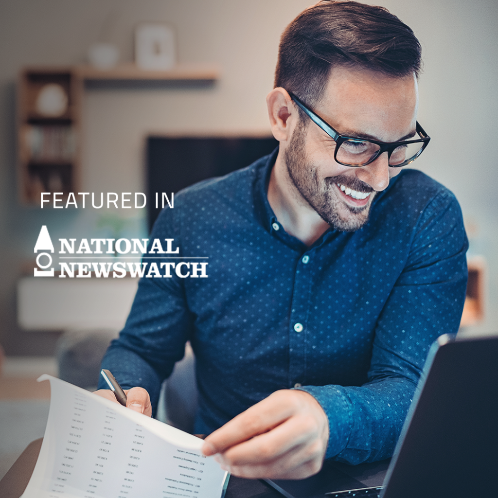 "Featured in National Newswatch" text over image of man in button-up shirt and glasses smiles as he works at his desk
